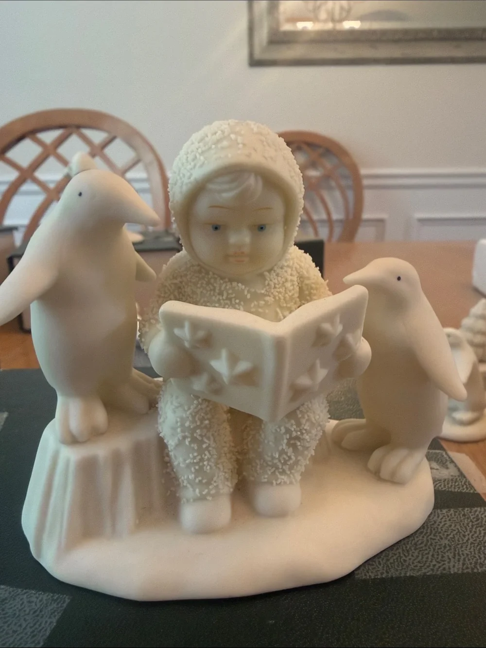 Department 56 Ivory Child Reading Figurine with Penguins “Read Me a Story!”